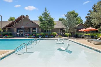 Outdoor pool with tanning shelf